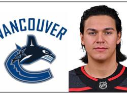 Ethan Bear with Vancouver Canucks logo