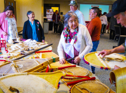 People gather to look at snowshoes and other crafts and handiworks.