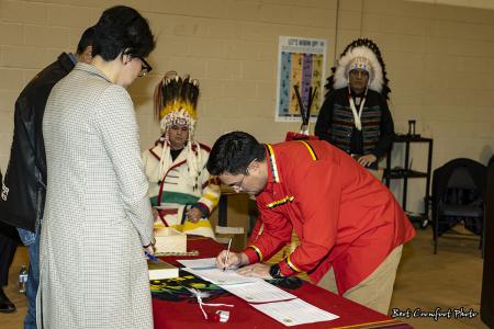 Councillor Samuel Crowfoot signs official documents