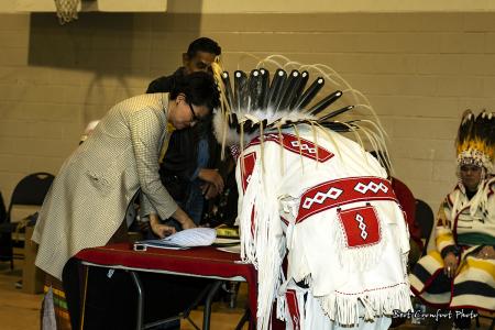Councillor Reuben (Buck) Breaker sings official documents
