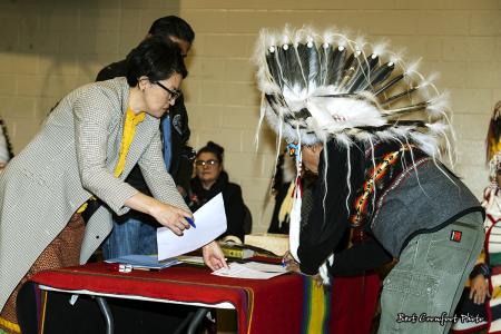 Councillor Leon Crane Bear signs official documents